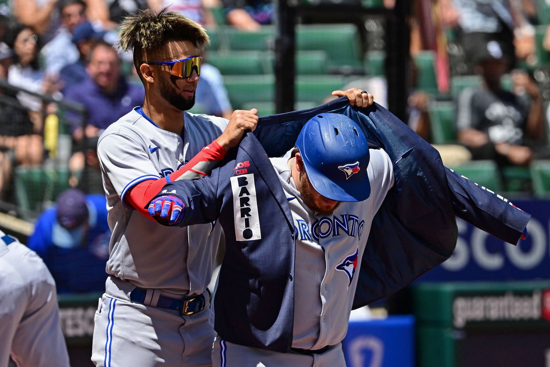 Lourdes Gurriel Jr. helps Alejandro Kirk don the home run jacket at a Toronto Blue Jays v Chicago White Sox game.